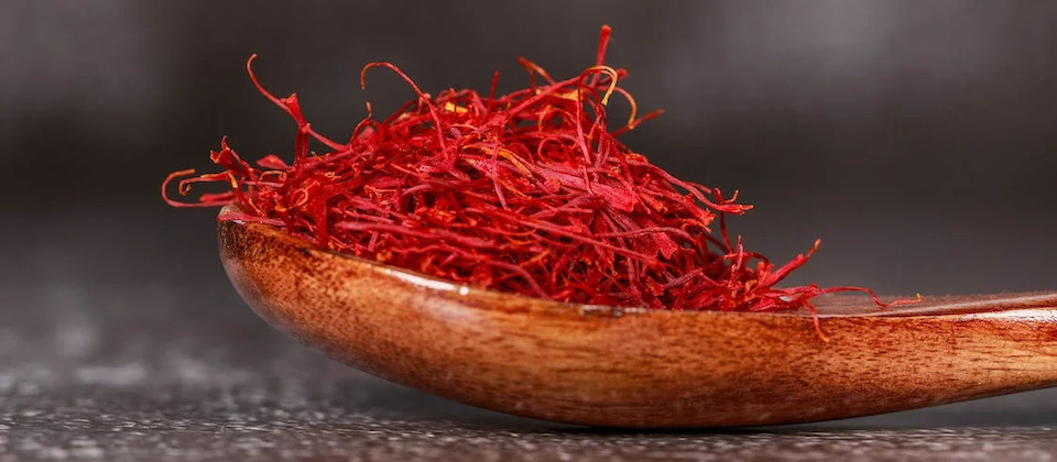 Red Saffron Spice on Brown Wooden Spoon