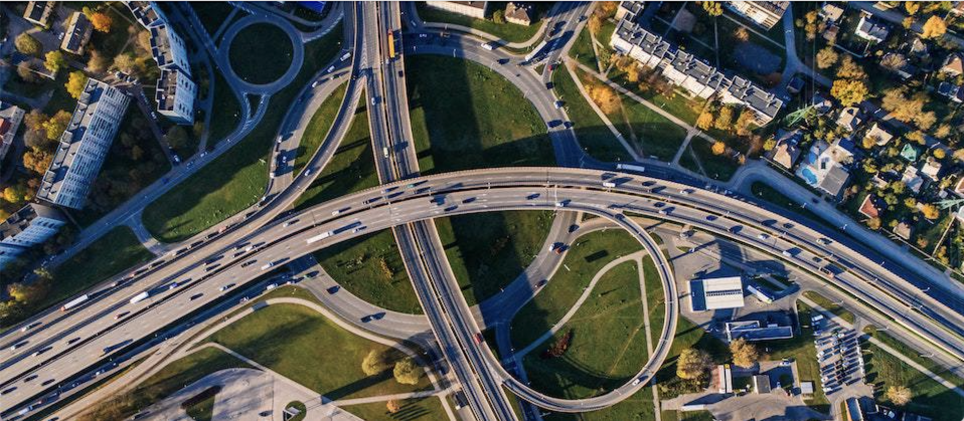 Bird's-eye view of a highway network and a roundabout.