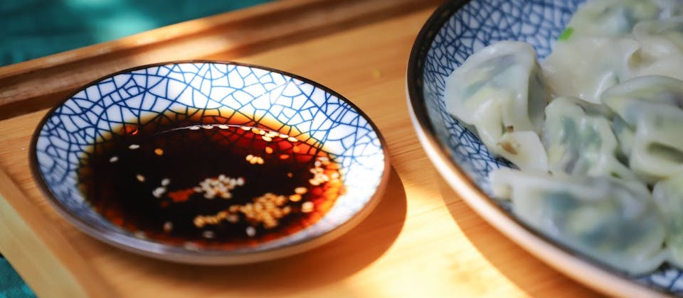 blue dish filled with soy sauce