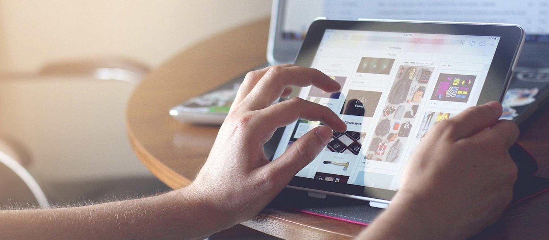 Person's hand touching an electronic tablet.