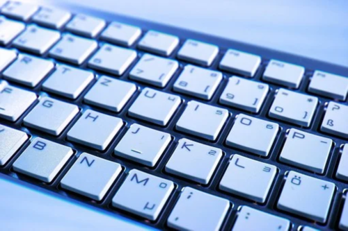 white keyboard with blue hue background