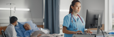 Patient in hospital bed receiving care from doctor