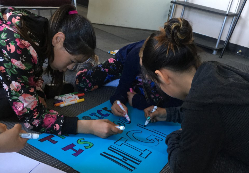 Group of girls drawing a poster
