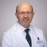 Headshot of Dr. Bassam Abdulkarim wearing a lab coat