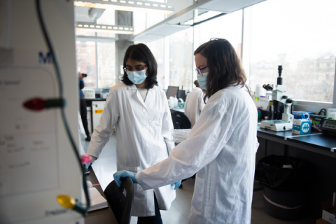 Two female scientists perform an experiment