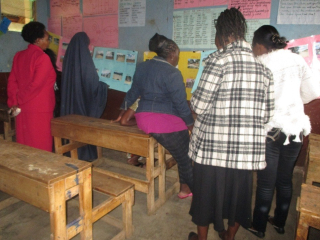 PhotoVoice focus group with women participants and Korogocho community stakeholders discussing PhotoVoice posters