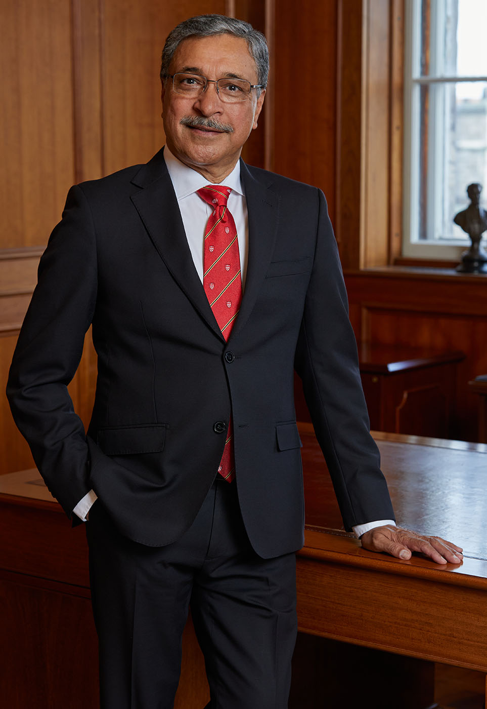Portrait of President Deep Saini standing in his office