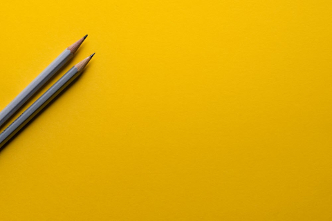 yellow background and 2 pencils 