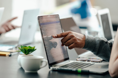 man pointing to a laptop
