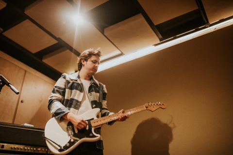 Musician playing electric guitar, aesthetic photography