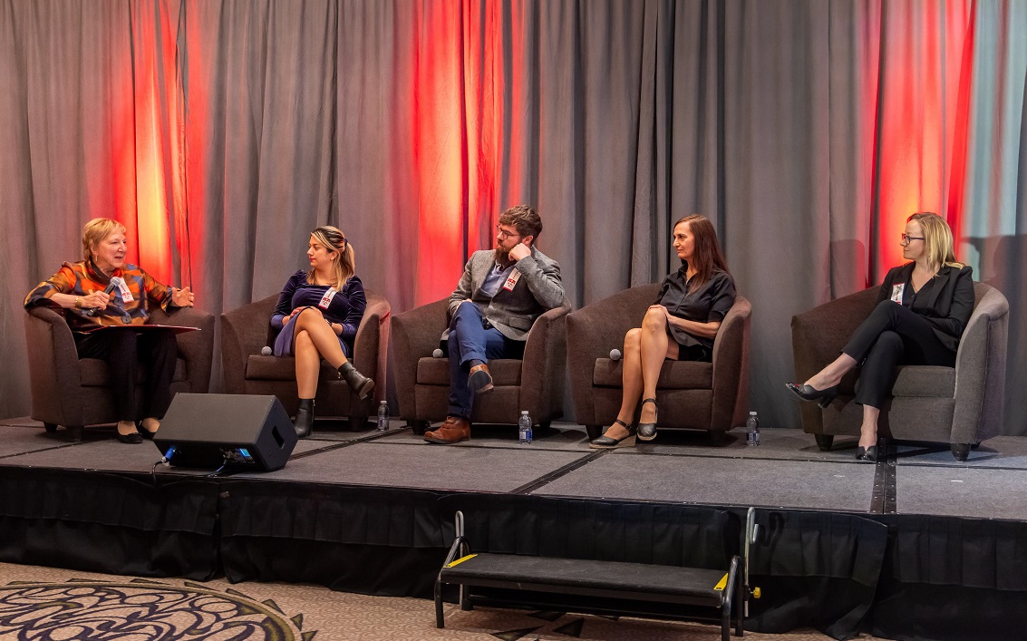 Panelists on stage at Bravo with EMCEE Martha Crago