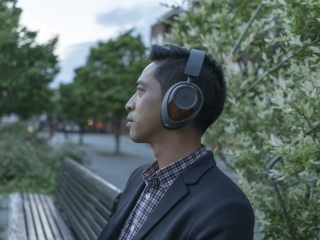 a man with headphones on in a park