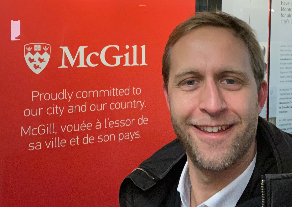 FAU's Prof. Björn Eskofier smiling in front of a McGill sign.