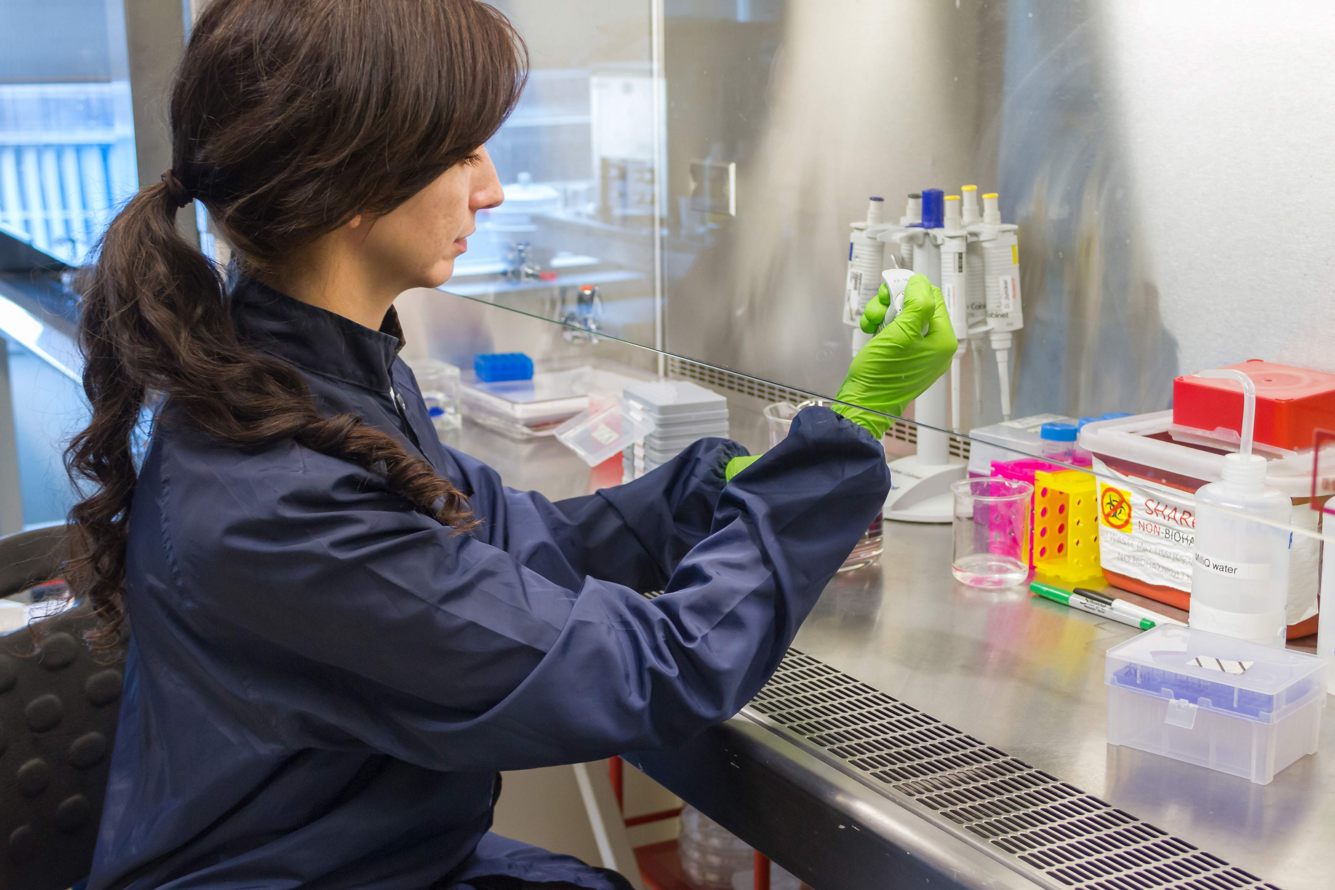 A scientist transferring liquids in a lab