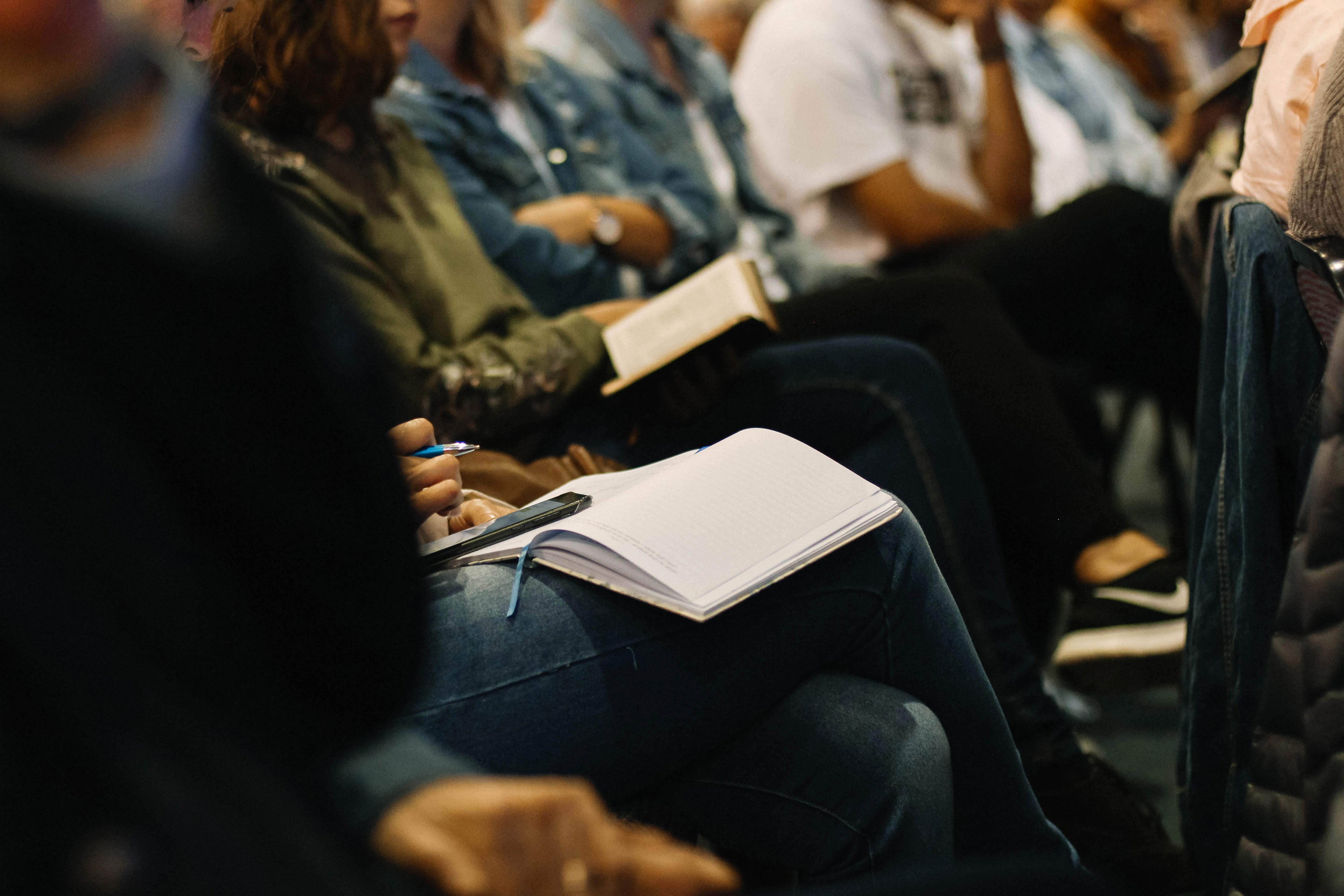 people sitting in an auditorium at a lecture or workshop