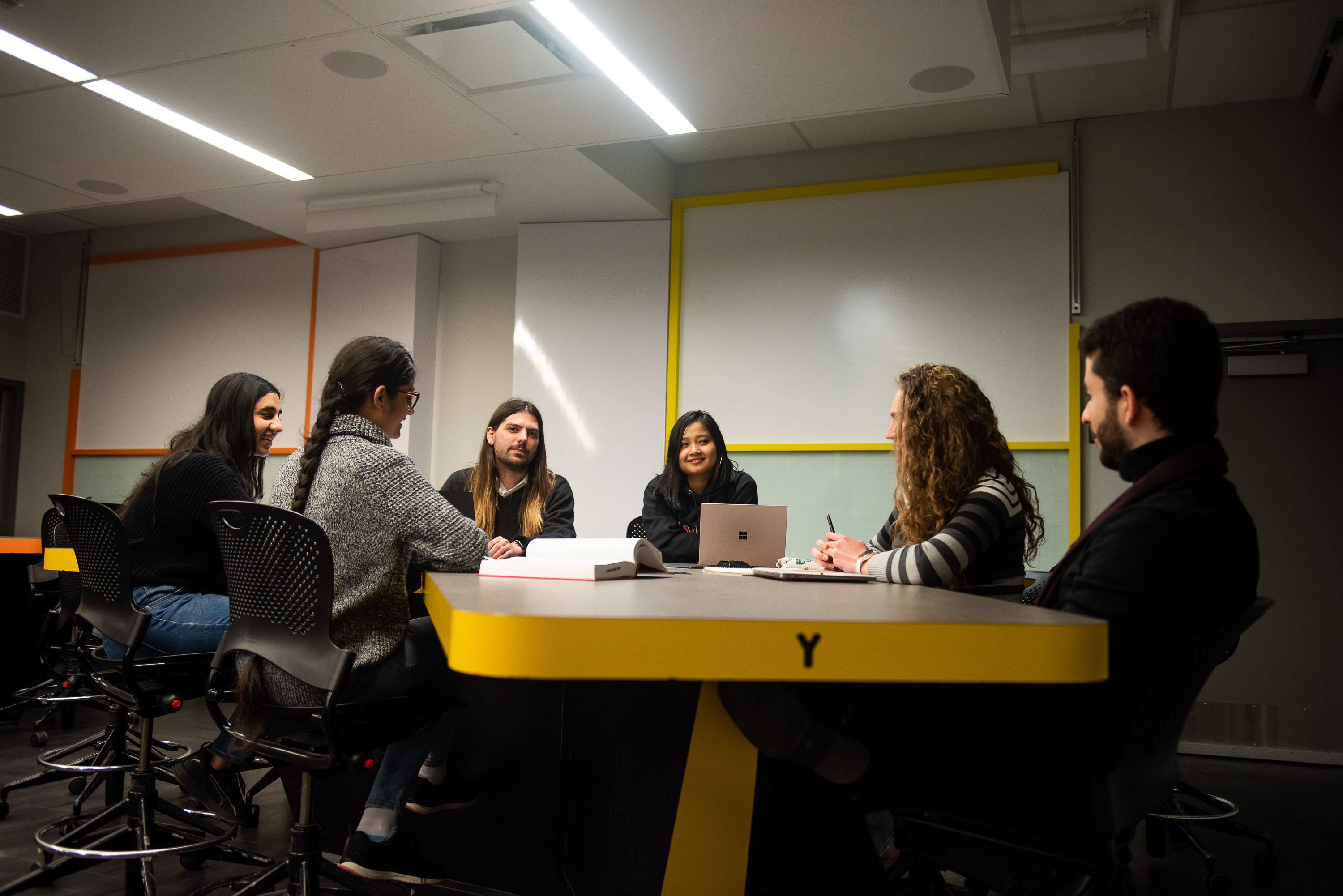 a group of people discussing around a table