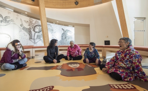 Elders sit on the floor of the Knowledge Sharing Centre at the CHARS building, Ikaluktutiak