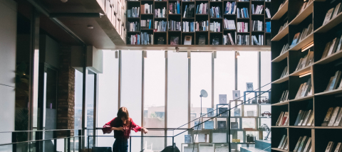 a woman standing in a modern library