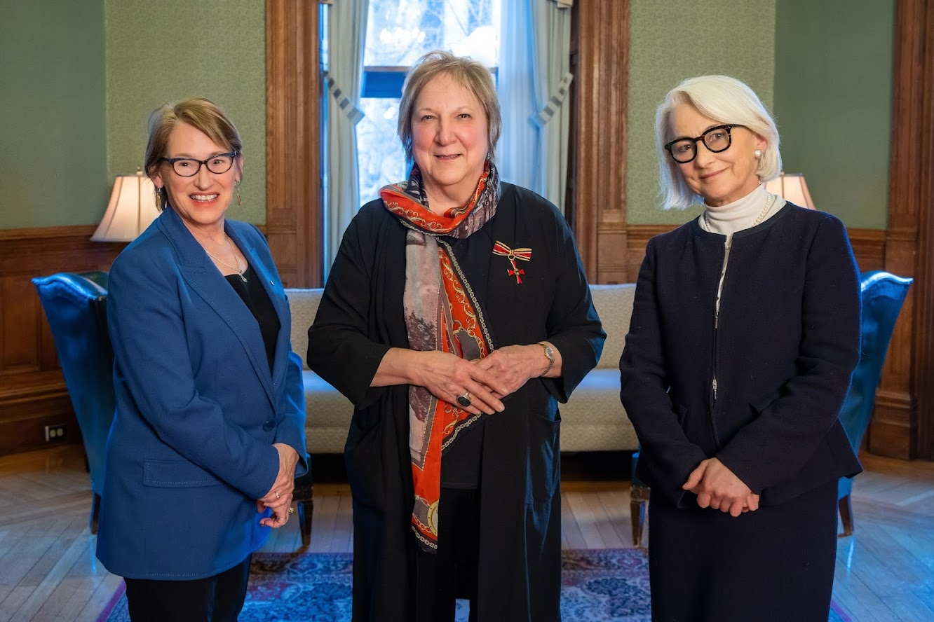 Principal Suzanne Fortier, Martha Crago, and Sabine Sparwasser standing together.