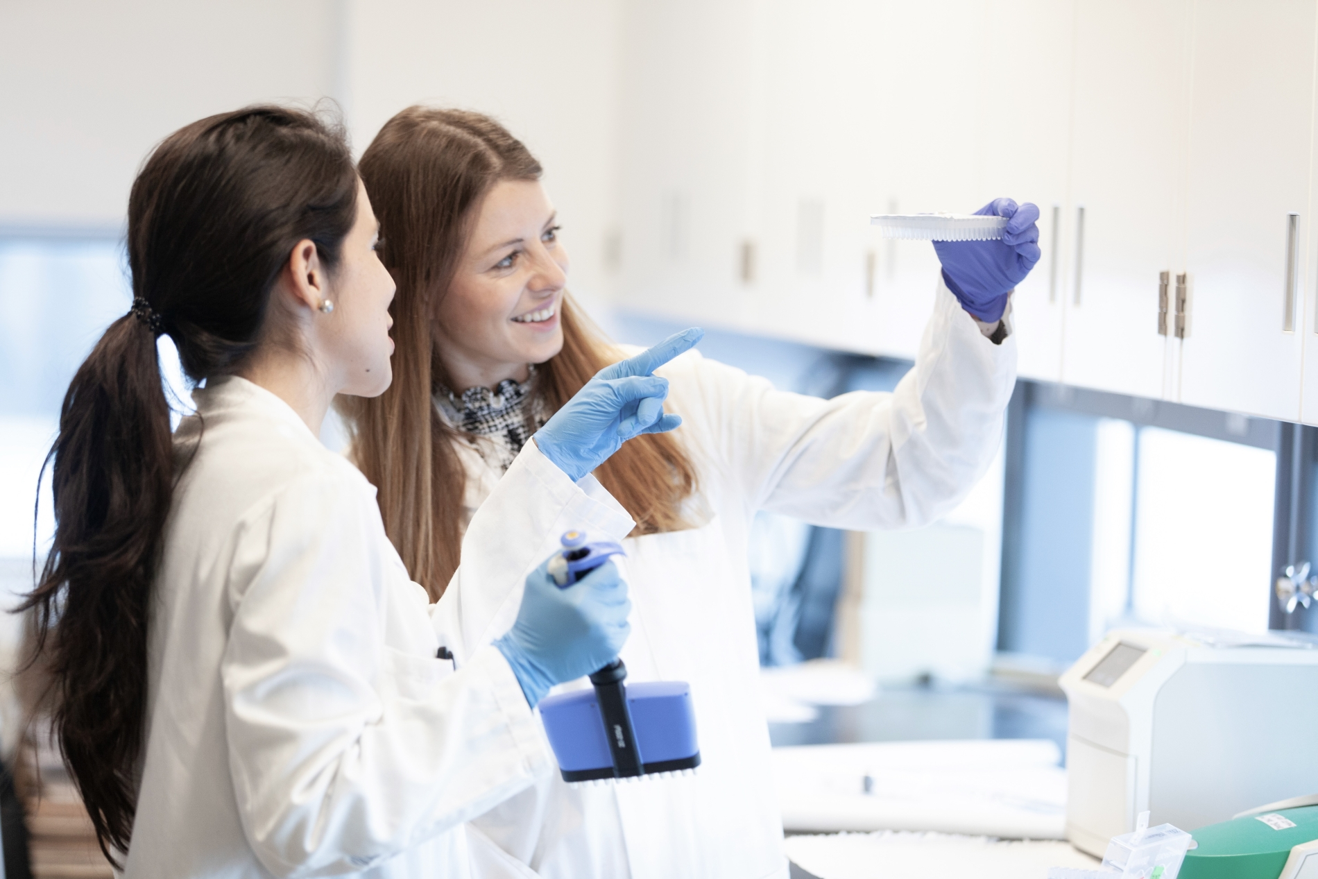 Two women examine a test tube