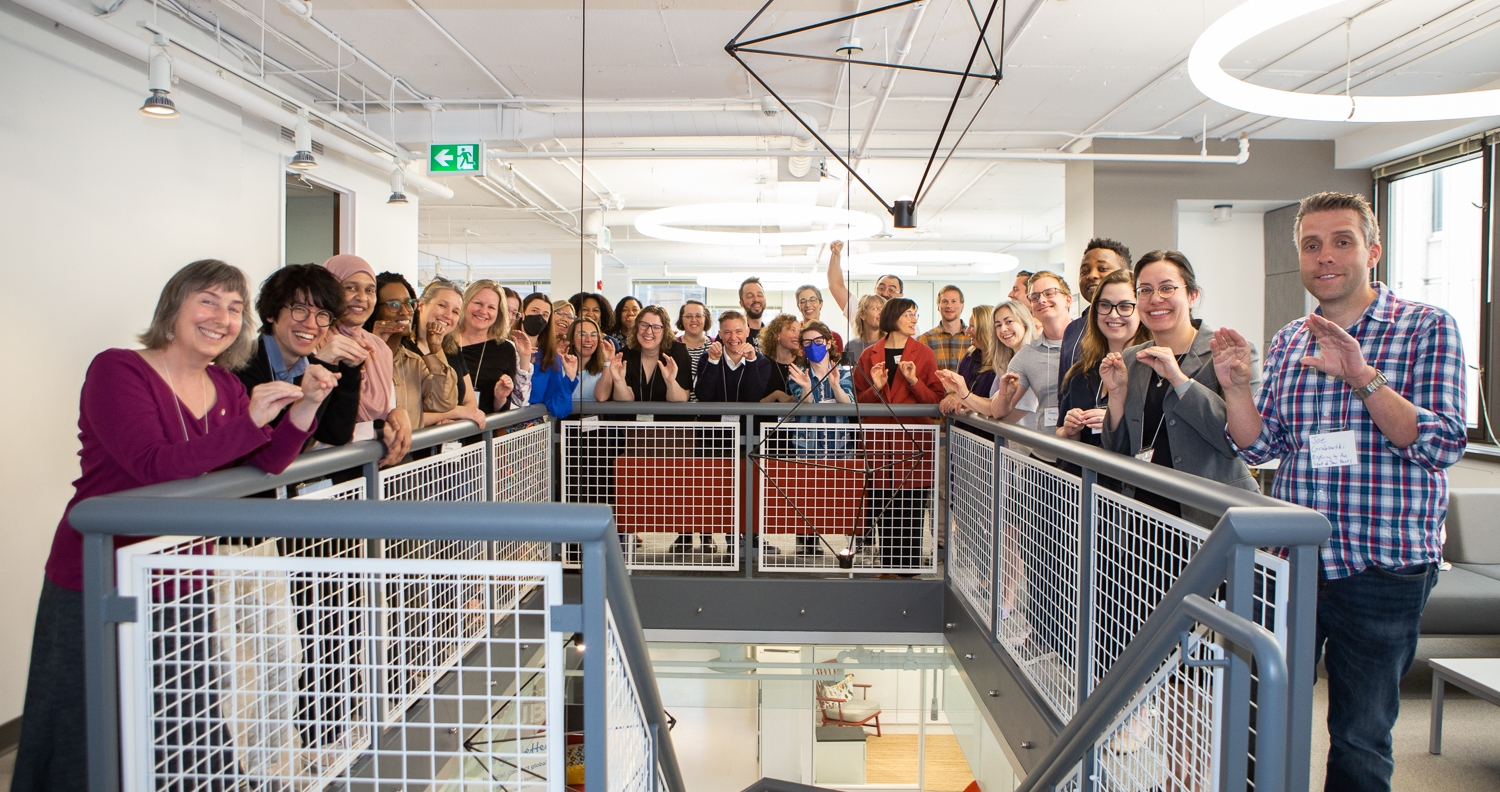 the group of participants standing around a staircase