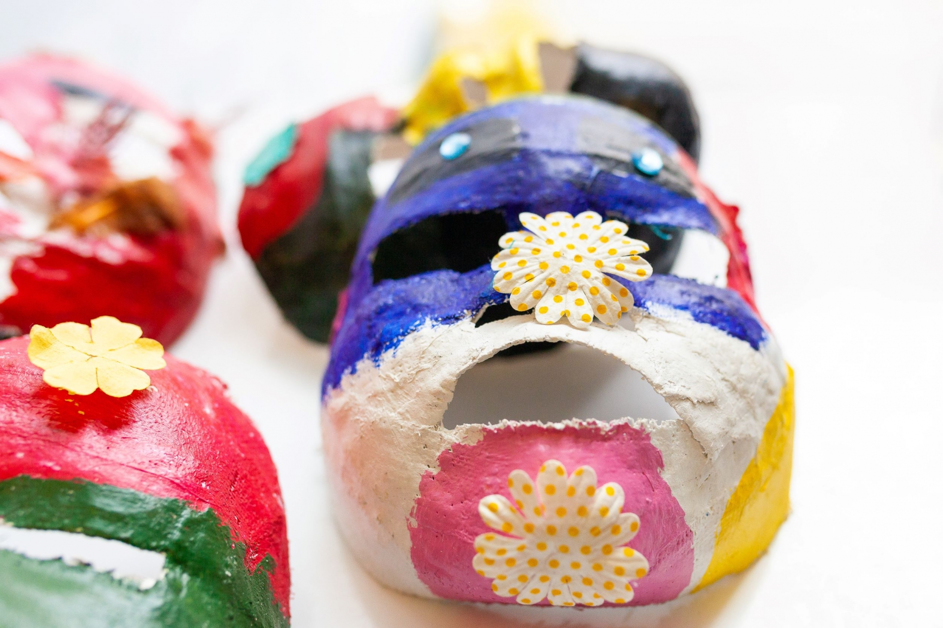 Plaster masks of children's faces, in multi-colour. Photo by Karene-Isabelle Jean-Baptiste.