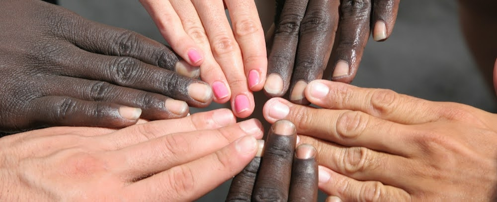 A group of hands touching fingers