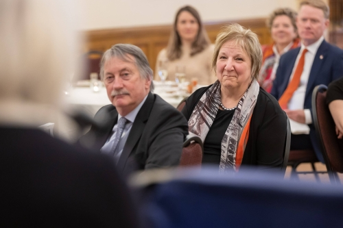 Martha Crago and Ted Hewitt sitting together at an event.