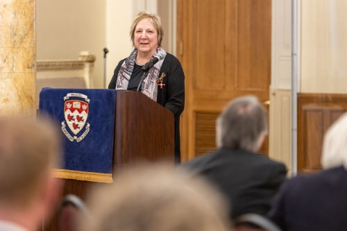 Martha Crago speaking at a podium.