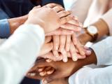 hands of people in stack indicating support and strength