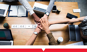 Team members working together at their desk