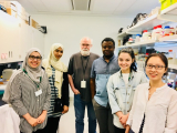 Dr. Watkins with previous lab members in the lab