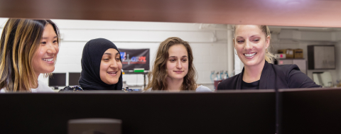 Four female students reviewing data