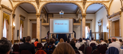 Woman speaking in front of a conference crowd