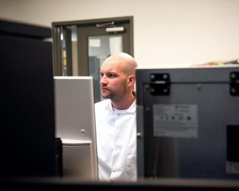 Scientist in a high tech lab looking at data