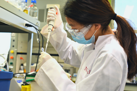 Young scientist uses pipette in a lab