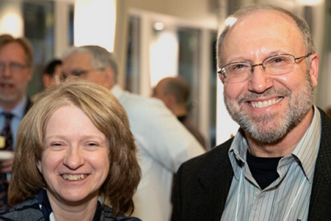 Faculty members pose at a symposium