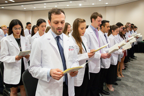 learners in white coat ceremony