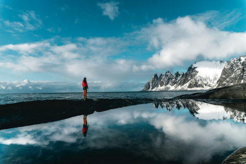 Student looking out at the ocean and mountains Image of student looking out at the ocean and mountains
