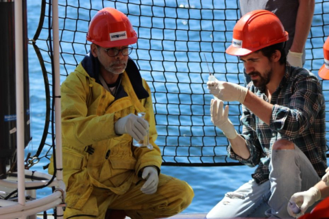 Alfonso Mucci (left) sampling water aboard the research vessel Coriolis II