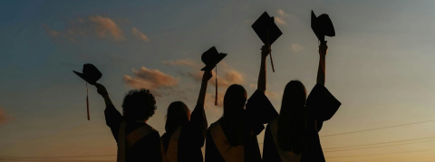 Group of friends graduating from university at sunset Graduating students at sunset