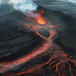 Smoking volcano with lava running down