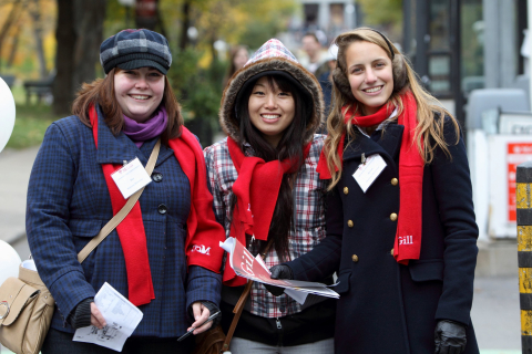 Three students wearing McGill scarves and nametags