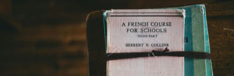 Stack of french books on a black table
