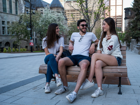 Students sitting on a bench on McTavish street