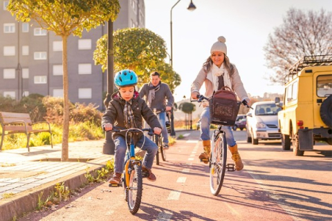 A woman and small boy commute on bike using an urban bicycle path