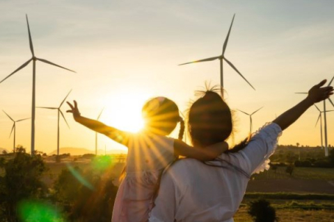 Mother and child with sun shining and windmills