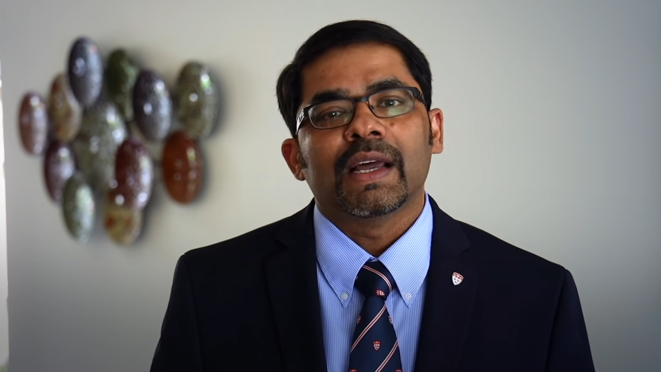Madhukar Pai during his convocation address wearing a suit with a McGill tie and pin