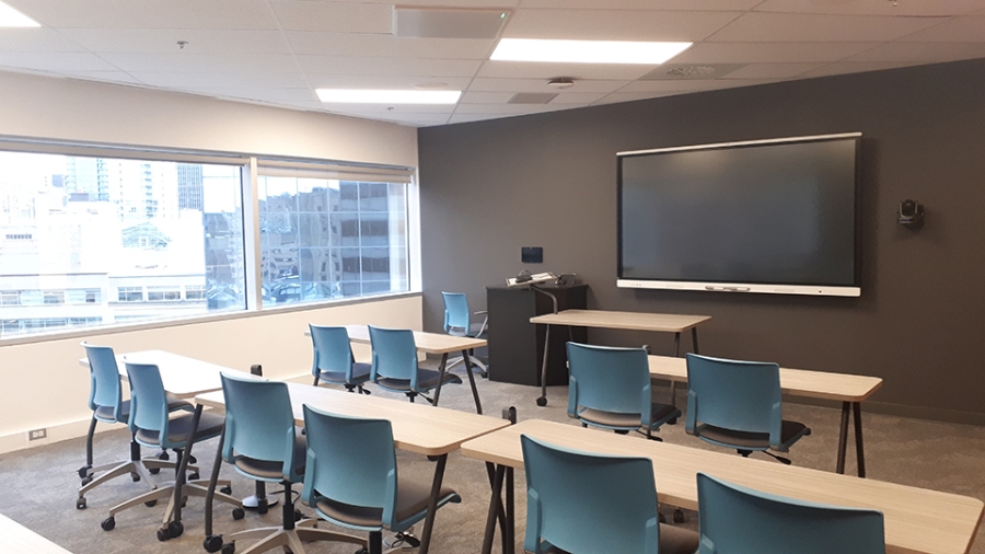Room 1203 at 2001 McGill College - Classroom with light blue desk chairs facing one screen