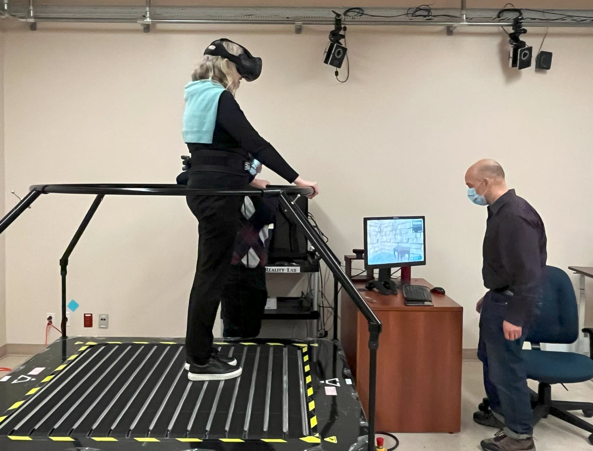 Prof Unsworth walking on an omnidirectional treadmill with virtual reality mask on while in the lab of Anouk Lamontagne PT, Ph.D